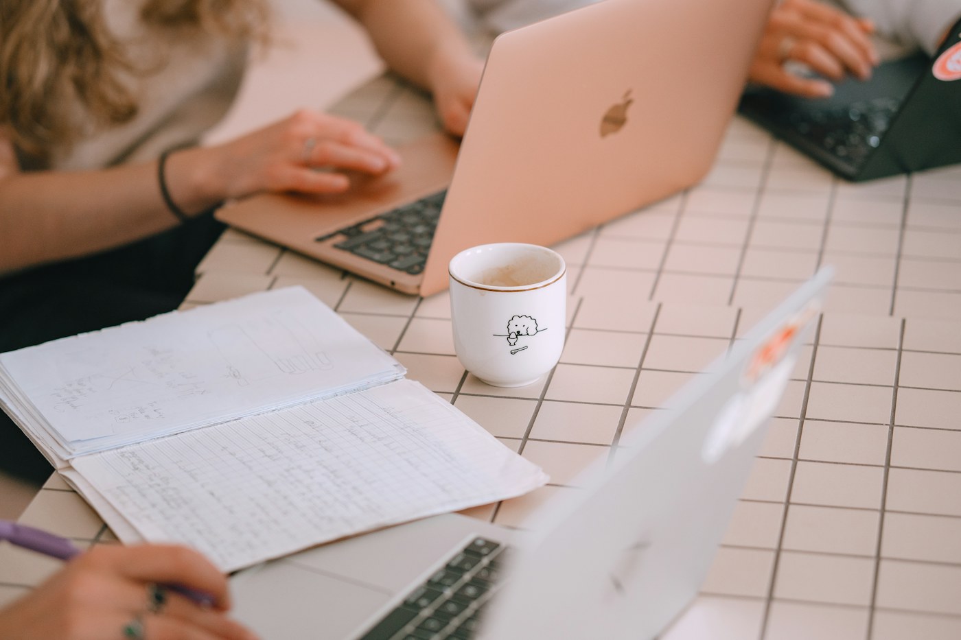A project planning process with laptops, notes and sketches